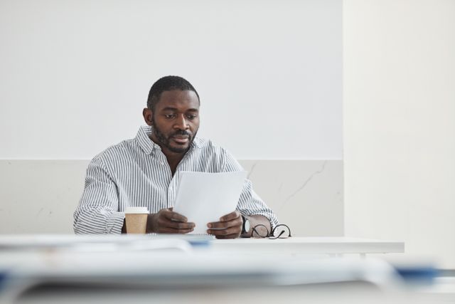 person seated at a desk reviewing a document